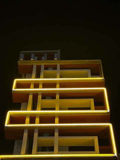 A neon yellow angular light