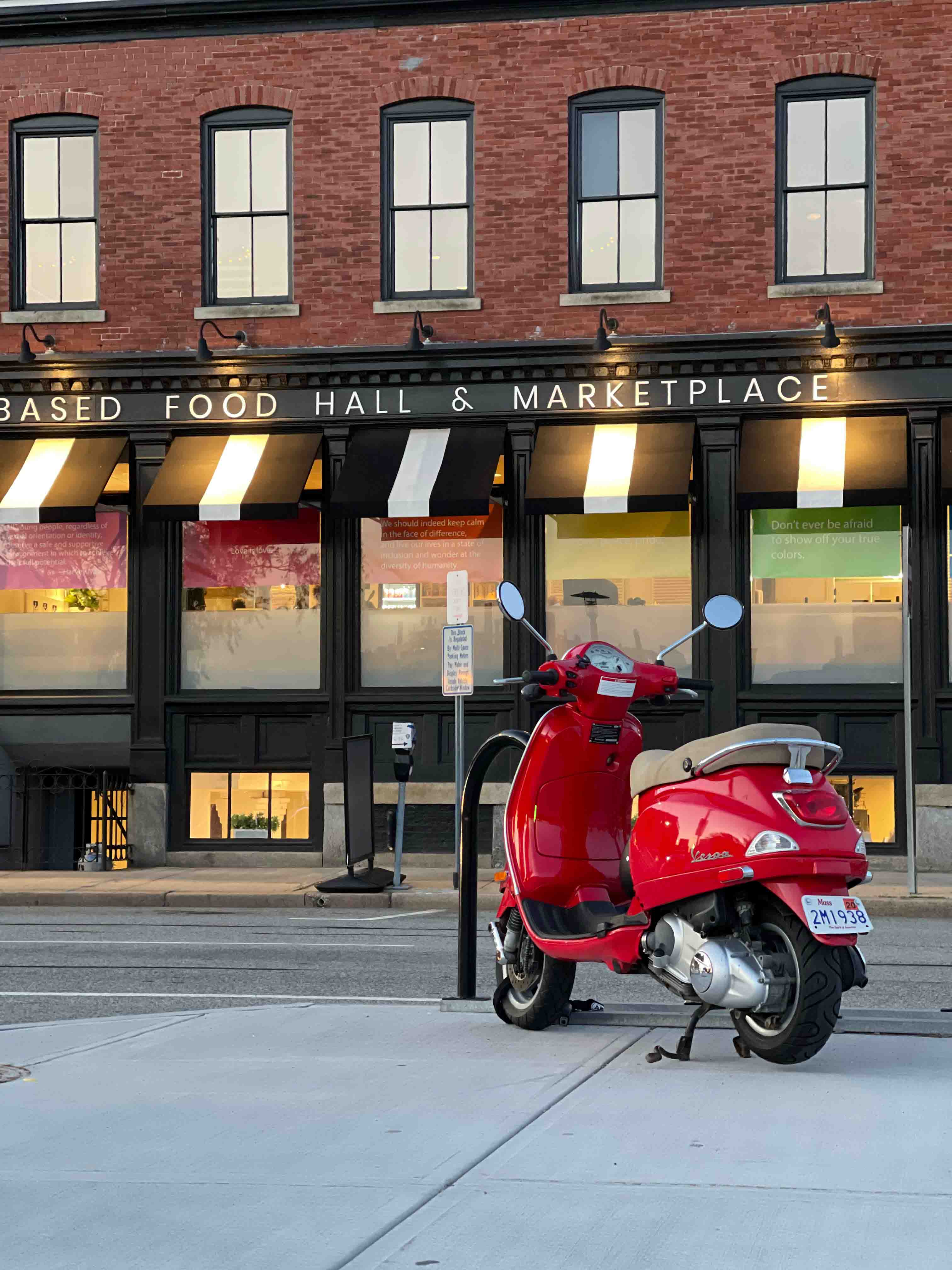 Red moped in front of a restaurant