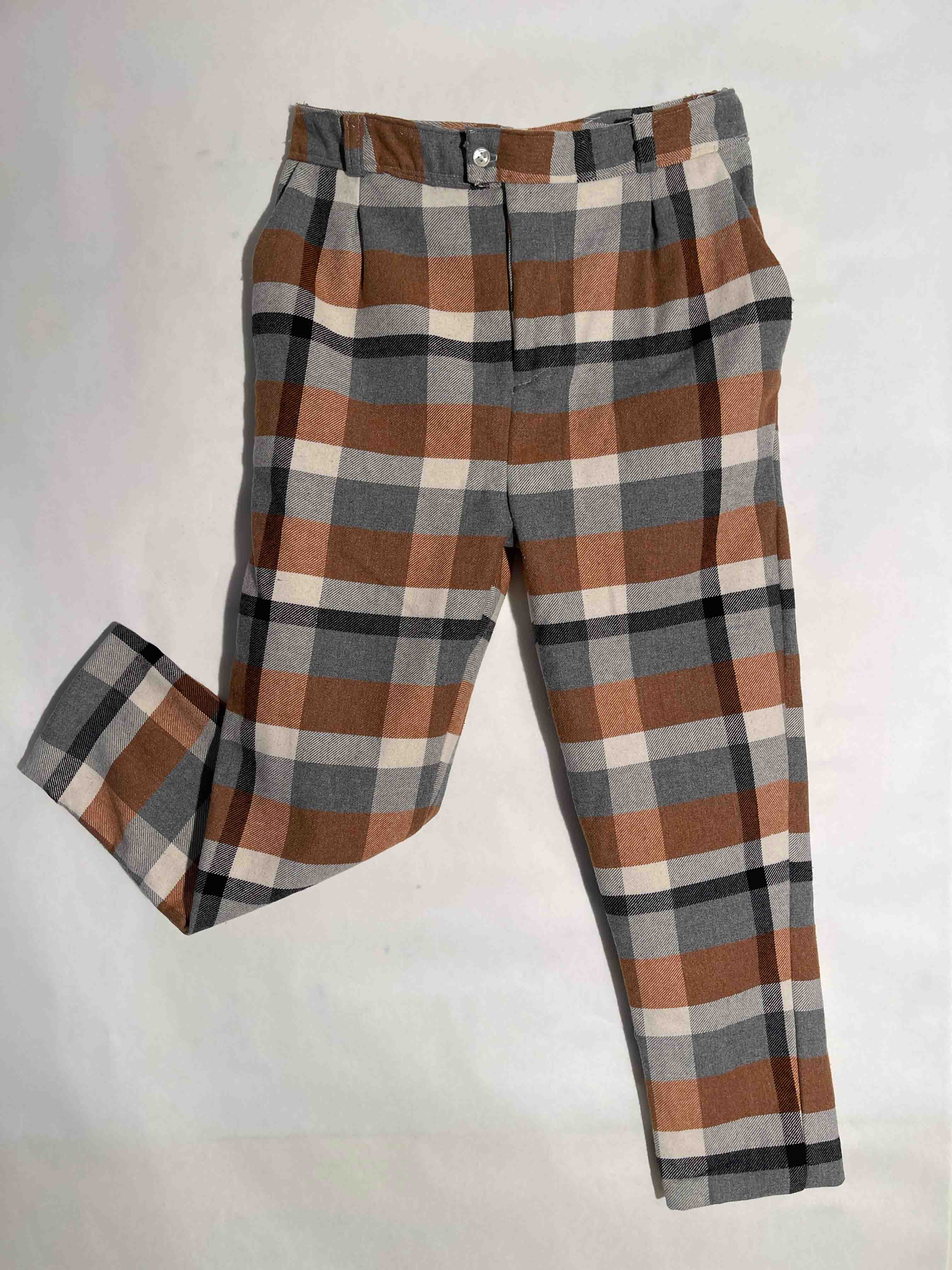 Orange and black plaid pants with one leg kicking back